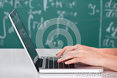 University student using laptop in classroom