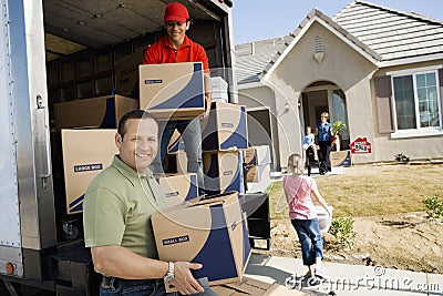 Unloading Delivery Van In Front Of House
