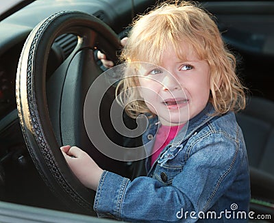 Upset little girl crying in the car, in soft focus