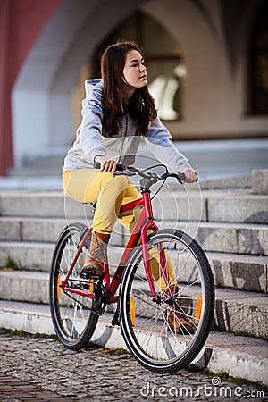 Urban biking - teenage girl and bike in city