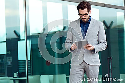 Urban business man with laptop outside in airport