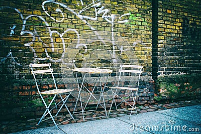 Urban outdoor seating with brick wall background
