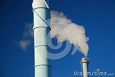 White smoke against blue sky. Urban Pollution