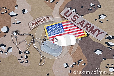 US ARMY ranger tab with blank dog tags on camouflage uniform