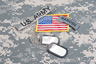 US ARMY ranger tab with blank dog tags on camouflage uniform