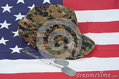 Us marine camouflage cap with blank dog tag on us flag backgroun