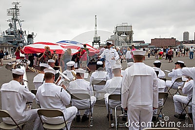 US Navy Band plays in front of US Flag