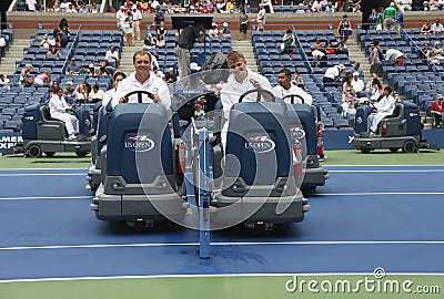 US Open cleaning crew drying tennis court after rain delay at Arthur Ashe Stadium