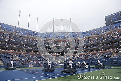 US Open cleaning crew drying tennis court after rain delay at Arthur Ashe Stadium