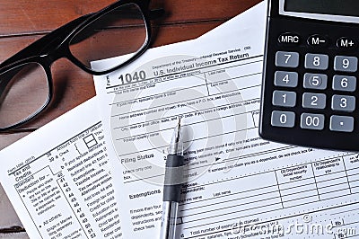 US 1040 Tax form with Glass, Pen And Calculator
