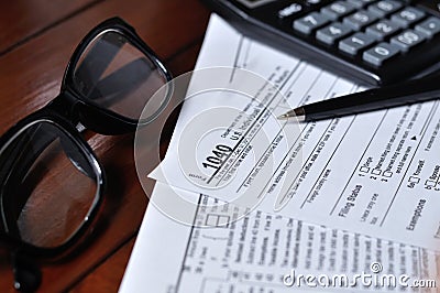 US 1040 Tax form with Glass, Pen And Calculator