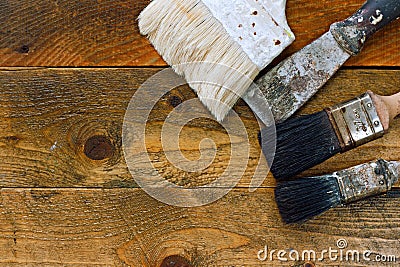 Used paintbrushes and scraper on old wooden table