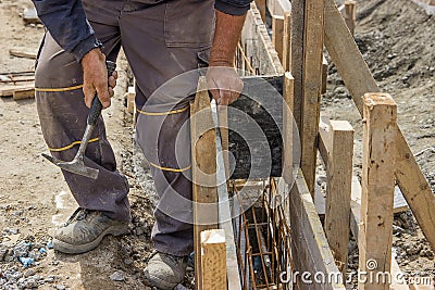 Using hammer and preparing form for concrete with reinforcing ro