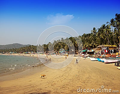 Vacationers, sellers, cafe on the tropical beach Palolem, on January 31, 2014 in Goa, India