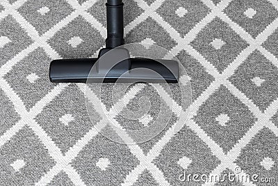 Vacuum cleaner on gray carpet