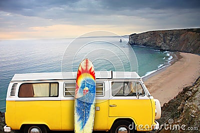 Van and surf board at a beach