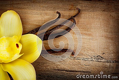 Vanilla Pods and Flower over Wood