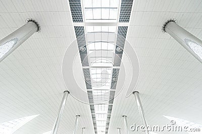 Metal columns and modern glass ceiling at airport.