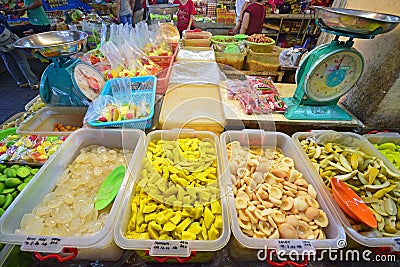 Variety of Close up Fruit pickles sold in Pulau Penang with two Large Weighing Machine