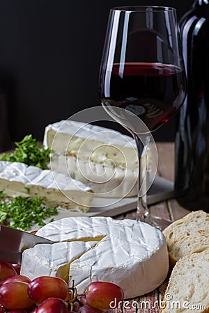 Varius cheese with red wine and grapes