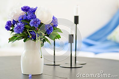 Vase of blue flowers in modern living room