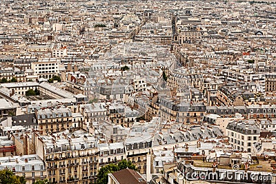 A vast sea of rooftops across a Paris cityscape