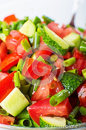 Vegetable salad with fresh tomatoes cucumbers and green onions