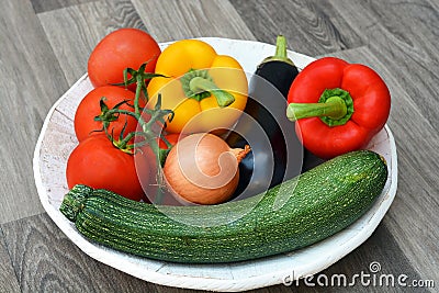 Vegetables colors on a white natural plate