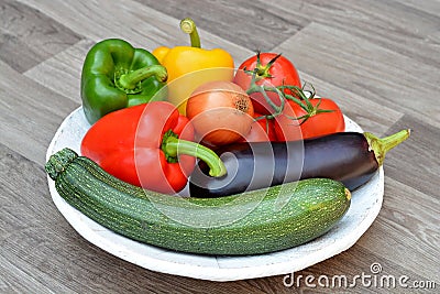 Vegetables colors on a white natural plate