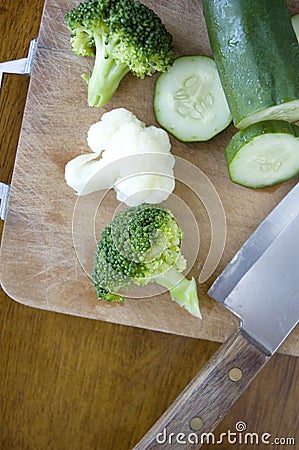Vegetables with knife on cutting board