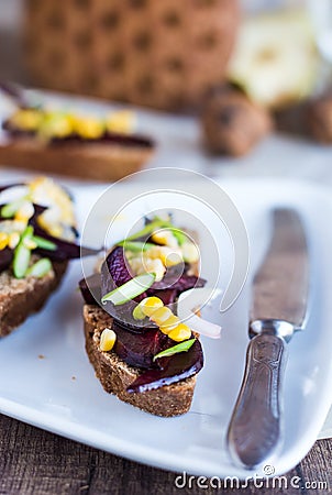 Vegetarian sandwich with vegetables on white plate,knife