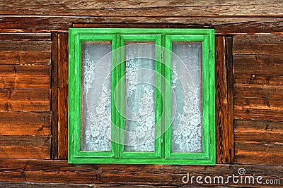 Ventana verde de una casa vieja rústica con las paredes de madera. Ventana verde de una casa vieja rústica con las paredes de madera.