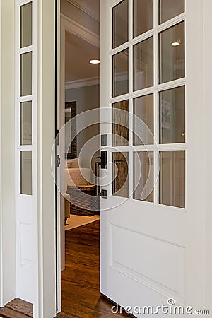 Vertical shot of an open, wooden front door