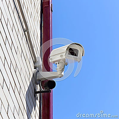 Video surveillance camera on a wall of the building