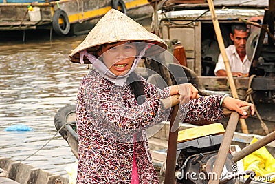 Vietnamese woman paddling on her boat