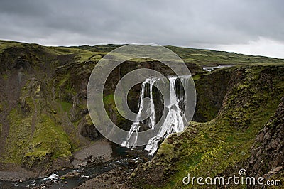 View of the Fagrifoss (Beautiful waterfall) on a cloudy evening,