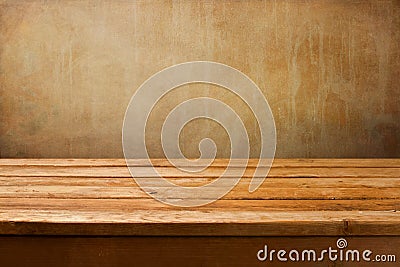 Vintage background with wooden deck table on a grunge wall