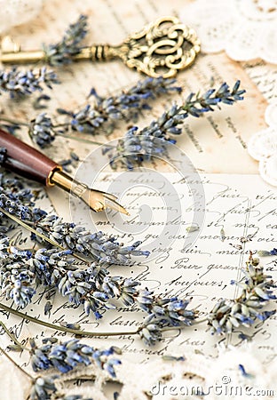 Vintage ink pen, key, lavender flowers and old love letters