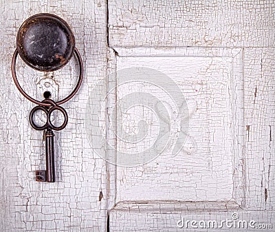 Vintage key hanging on a vintage door