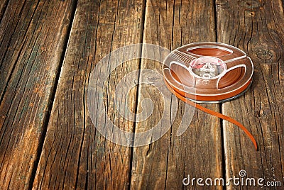 Vintage magnetic audio reel on wooden table. music concept background.