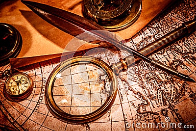 Vintage magnifying glass lies on an ancient world map