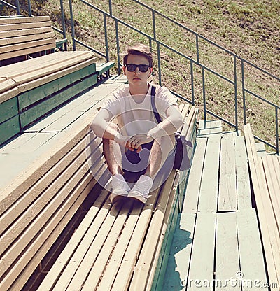 Vintage photo modern hipster man resting on the bench