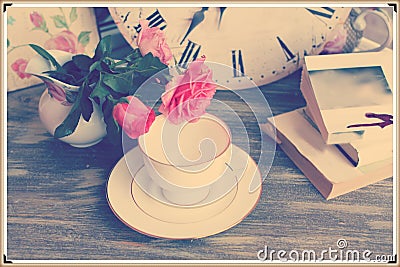 Vintage still life with roses cup and books