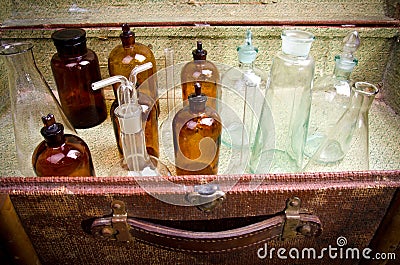 Vintage suitcase with chemical flasks and banks