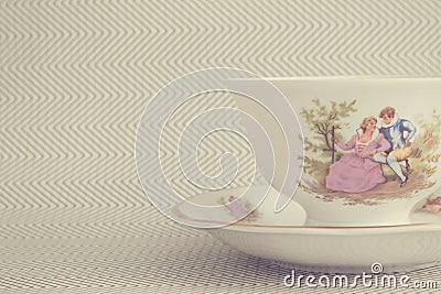 Vintage tea cup over background with zigzags