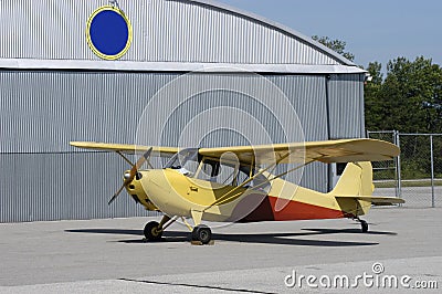 Vintage Trainer Aircraft Parked By Airport Hanger