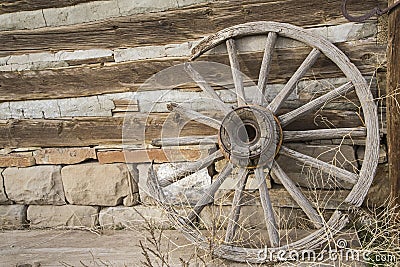 Vintage wheel weeds log and stone wall