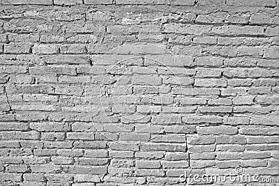 Vintage white brick wall with cracked concrete