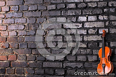 Violin on brick wall background for text music