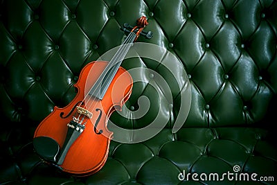 Violin on luxury green leather sofa